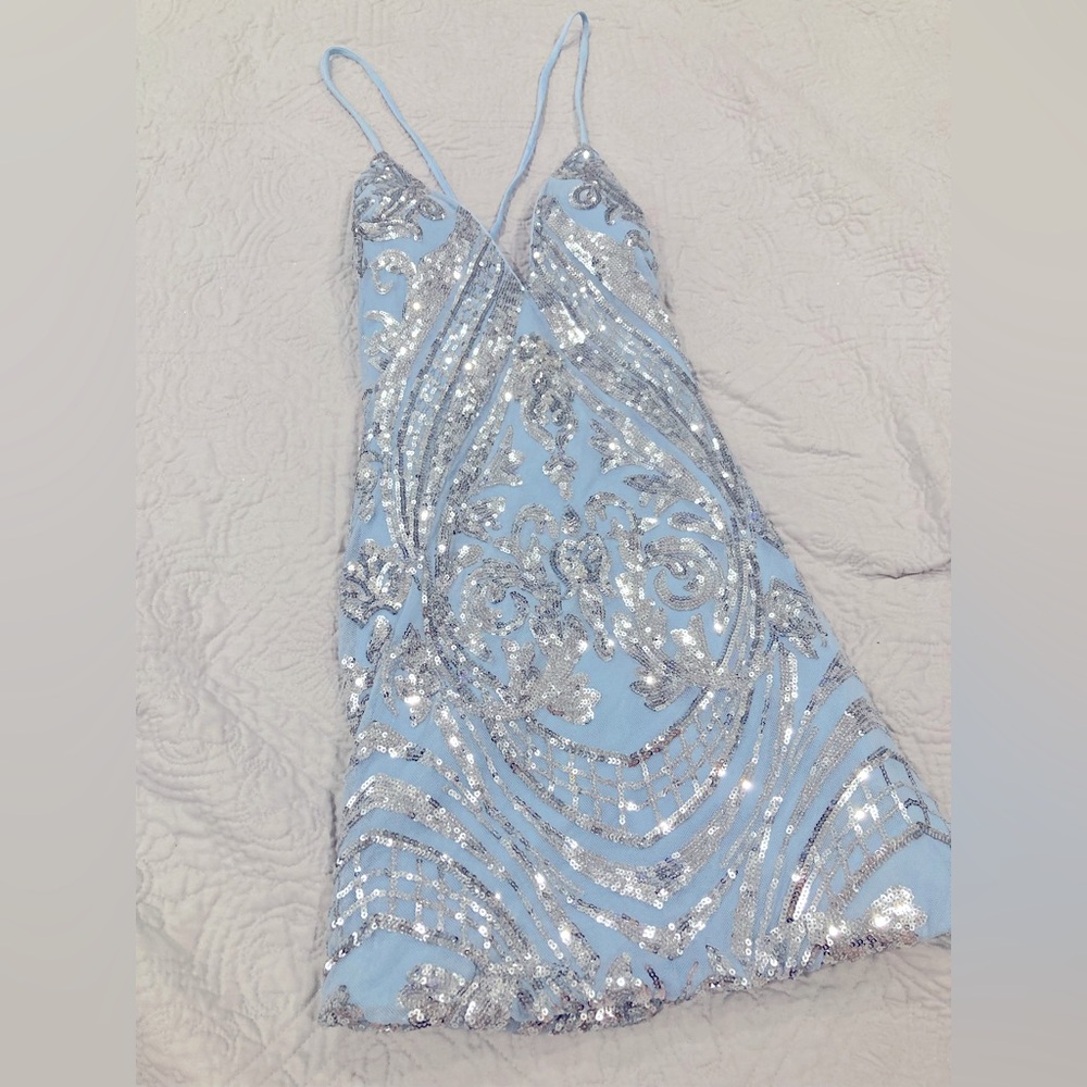 Small, blue dress with sequence design, low V neck, tie cross over back.